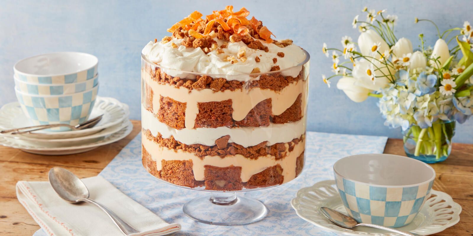 Carrot Cake Trifle in a glass dish showing distinct layers of cake, whipped cream, and speculoos cookies.