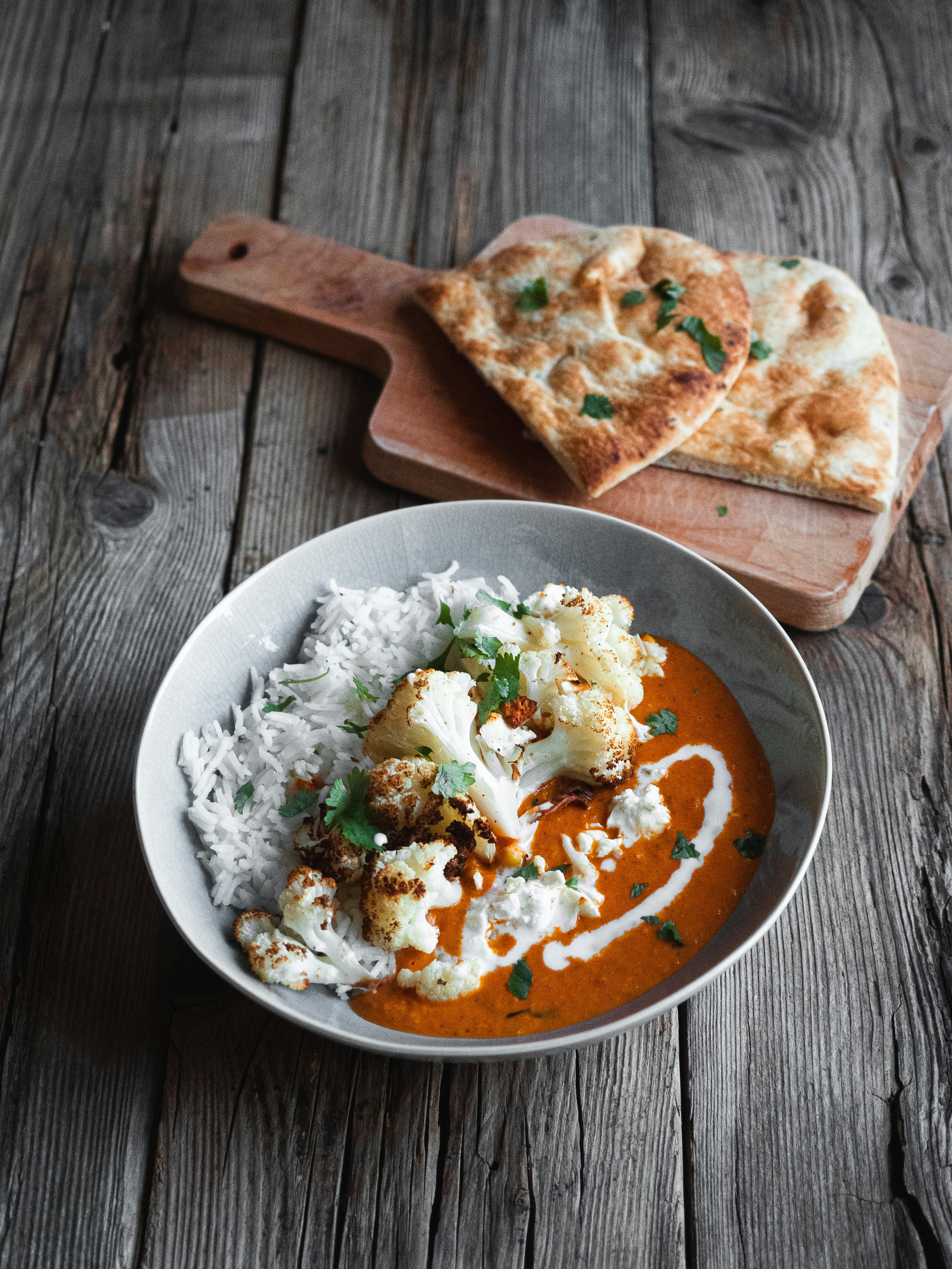 Slow-Cooked Curry with Fluffy Rice, Roasted Cauliflower, and Homemade Naan