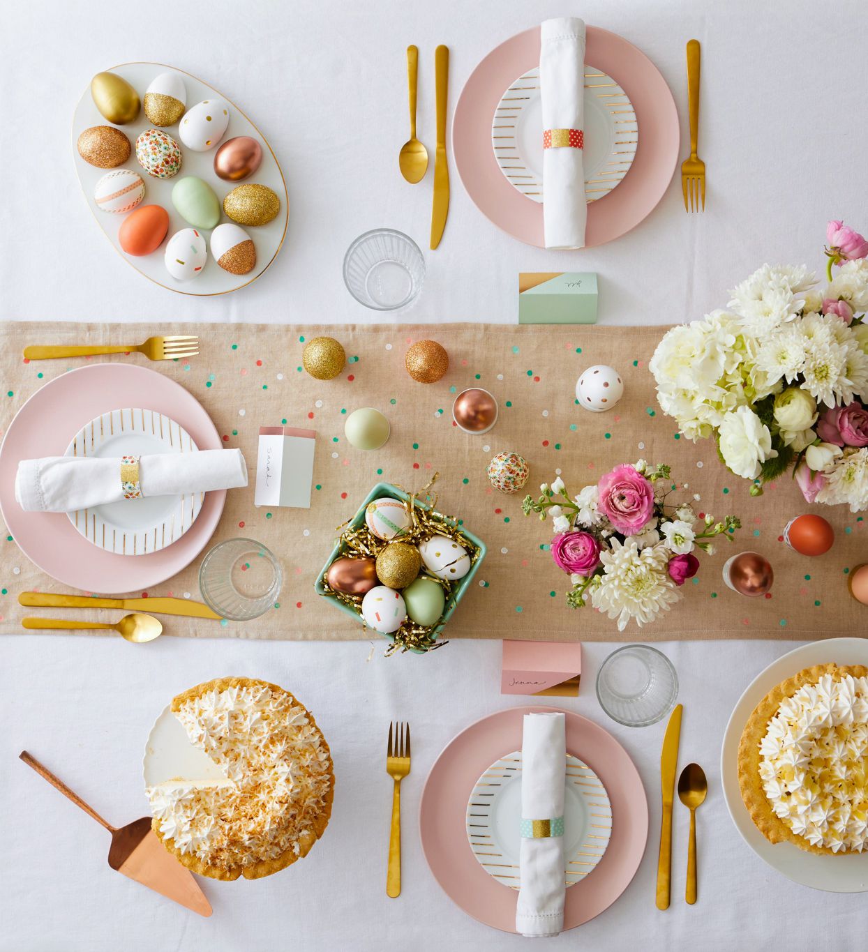 A beautifully set Easter brunch table with pastel-colored dishes, floral centerpieces, and Easter-themed decorations.